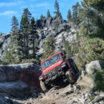 Jeep driving over rocky trail