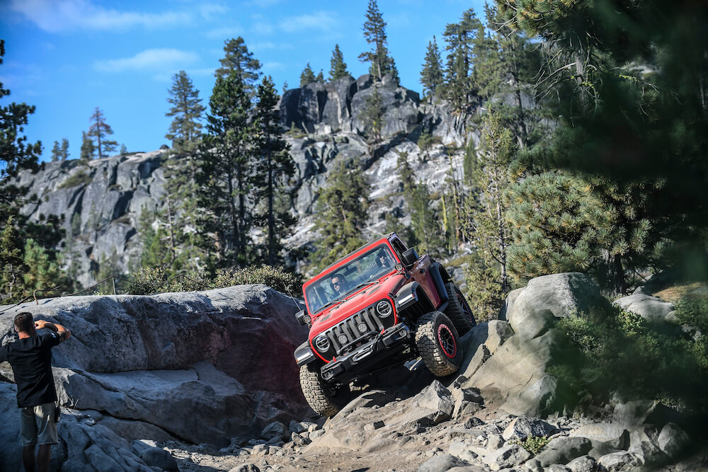 Jeep driving over rocky trail